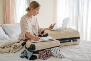 Travel.Suitcase.Girl traveler packing luggage in suitcase Travel,tourism,vacation,relocation.Mental health twellness,travel vacation.Unity, eco travel,travelling,good moments, digital detox