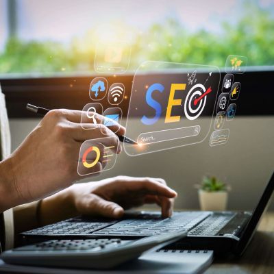 man working on a laptop and seeing a virtual SEO in the air